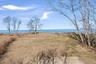 Open bluff-top clearing with sweeping water views and a serene natural backdrop, offering an exceptional setting along the shoreline
