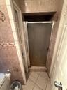 Full bathroom with a shower stall and light tile patterned floors
