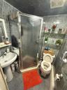 Full bath featuring a shower stall and tile walls