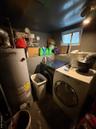 Laundry room with water heater and independent washer and dryer