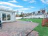 Fenced backyard with a patio