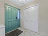 Entrance foyer featuring light tile patterned floors and a chandelier