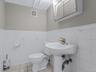 Bathroom featuring tile walls, a wainscoted wall, and light tile patterned floors
