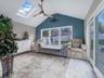 Bedroom featuring a skylight, access to exterior, lofted ceiling, and ceiling fan