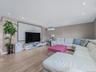 Living area featuring light wood-type flooring, recessed lighting, a wall mounted air conditioner, and vaulted ceiling
