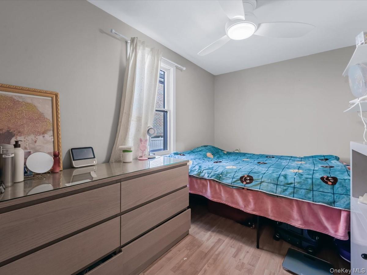Bedroom with light wood-style flooring and ceiling fan