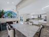 Dining space with lofted ceiling, recessed lighting, and wine cooler