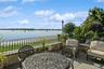 View of patio featuring a water view and outdoor dining area