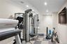 Workout room featuring light flooring, recessed lighting, and ornamental molding