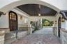 Property entrance with stucco siding and covered porch