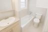 Full bathroom featuring a bath, vanity, tile walls, and tile patterned flooring