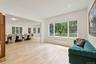 Sitting room featuring light wood finished floors, radiator, and recessed lighting
