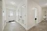 Foyer entrance featuring baseboards and light tile patterned floors