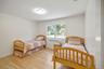 Bedroom featuring light wood-type flooring and radiator