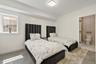 Bedroom with connected bathroom and baseboards