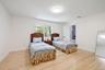 Bedroom with light wood-type flooring and baseboards