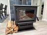 Detailed view of wood finished floors and a glass covered fireplace