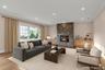 Living room featuring ornamental molding, a stone fireplace, wood finished floors, and recessed lighting