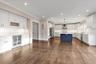 Kitchen featuring ornamental molding, white cabinetry, decorative light fixtures, decorative backsplash, and dark wood-style flooring