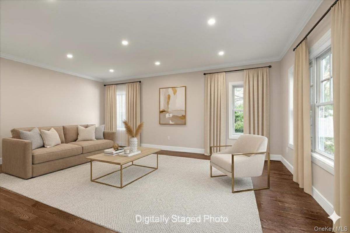 Living area featuring dark wood finished floors, ornamental molding, recessed lighting, and plenty of natural light