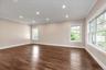 Empty room featuring dark wood finished floors, recessed lighting, and ornamental molding