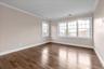 Spare room with crown molding and hardwood / wood-style floors