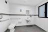 Half bathroom with tile patterned floors and tile walls