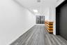 Spare room featuring a skylight, elevator, and wood finished floors