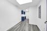 Spare room featuring electric panel and light wood-type flooring
