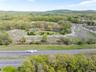 Birds eye view of property with a view of trees and a mountain view