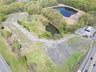 Birds eye view of property featuring a water view and a forest view