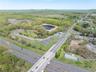 Bird's eye view with a water view and a wooded view