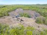 Birds eye view of property featuring a wooded view