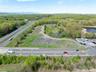 Birds eye view of property featuring a water view and a wooded view