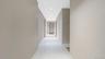 Hallway featuring light marble finish floors and recessed lighting