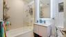 Full bath with vanity, shower / washtub combination, and backsplash