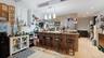 Kitchen with a peninsula, a breakfast bar area, appliances with stainless steel finishes, pendant lighting, and light wood finished floors