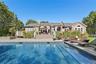 Rear view of property with a patio, a deck, roof with shingles, and an outdoor pool