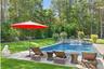 Outdoor pool with a lawn and a patio