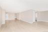 Unfurnished room featuring light wood finished floors and baseboards