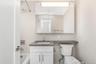 Full bath with vanity, washtub / shower combination, and tile walls