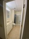 Bathroom featuring a paneled ceiling, a stall shower, vanity, and light tile patterned flooring