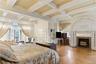 Primary bedroom with original herringbone oak floors and stunning  carved fireplace