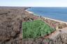 View of property location with property parcel outlined and expansive coastline