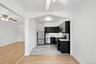 Kitchen featuring dark cabinets, ceiling fan, appliances with stainless steel finishes, tasteful backsplash, and crown molding