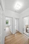 Hallway featuring ornamental molding and light wood-style floors