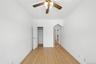 Unfurnished bedroom featuring ornamental molding, light wood-type flooring, a closet, and ceiling fan