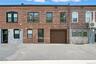 View of front of house featuring brick siding and a garage