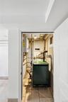 Utility room with water heater and a heating unit