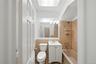 Full bath featuring vanity, bathtub / shower combination, and tile walls